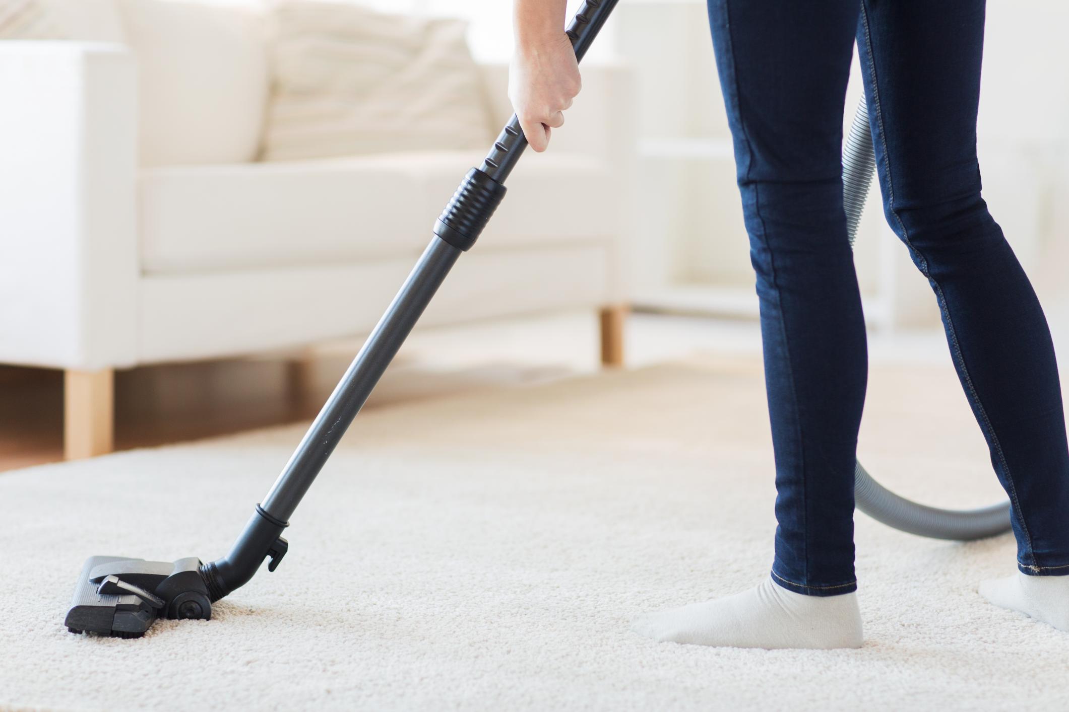 Woman Cleaning a Carpet